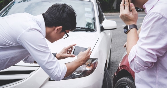 men discussing aftermath of a car accident