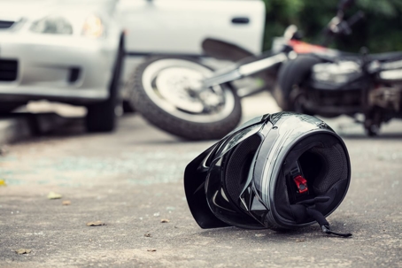 Motorcycle accident with a helmet on a road