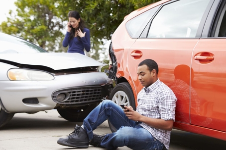 Two drivers on their phones after having an accident