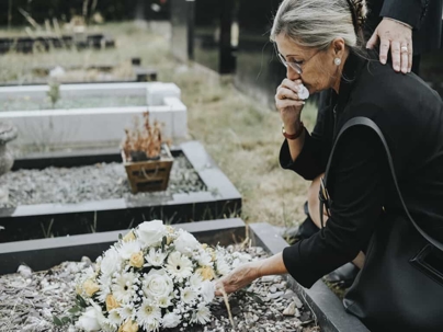 woman crying over a grave after wrongful death