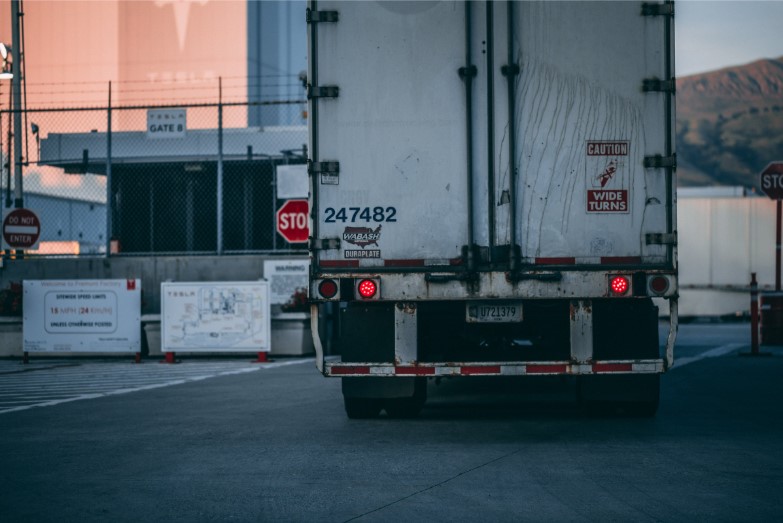 semi truck driving through a checkpoint
